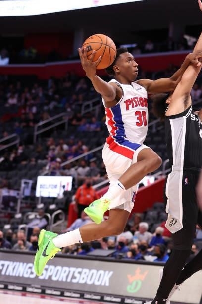 Saben Lee of the Detroit Pistons drives to the basket against Derrick White of the San Antonio Spurs during a preseason game at Little Caesars Arena...
