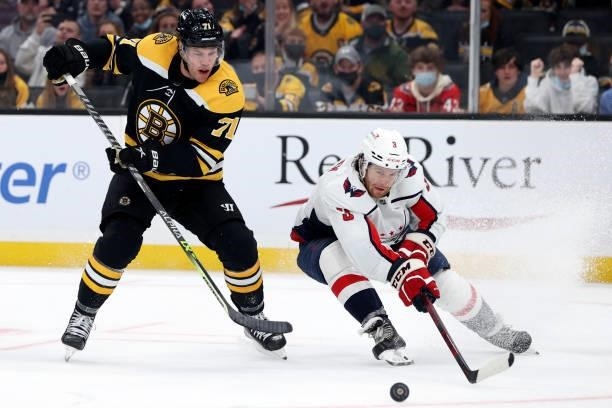 Taylor Hall of the Boston Bruins and Nick Jensen of the Washington Capitals battle for control of the puck during the third period of the preseason...