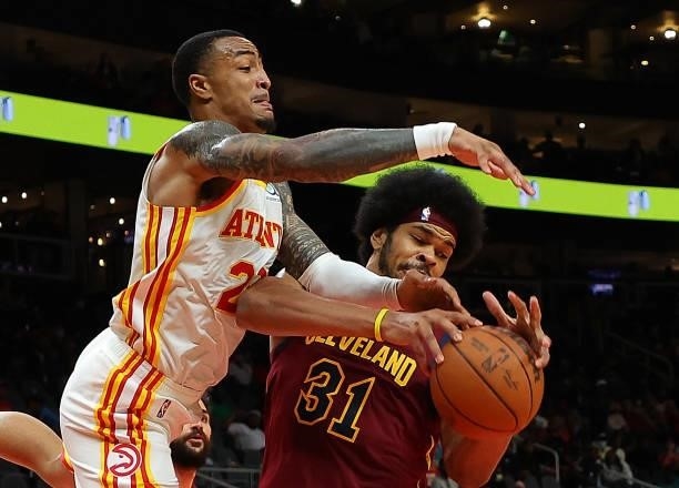 Jarrett Allen of the Cleveland Cavaliers and John Collins of the Atlanta Hawks battle for a rebound during the second half at State Farm Arena on...