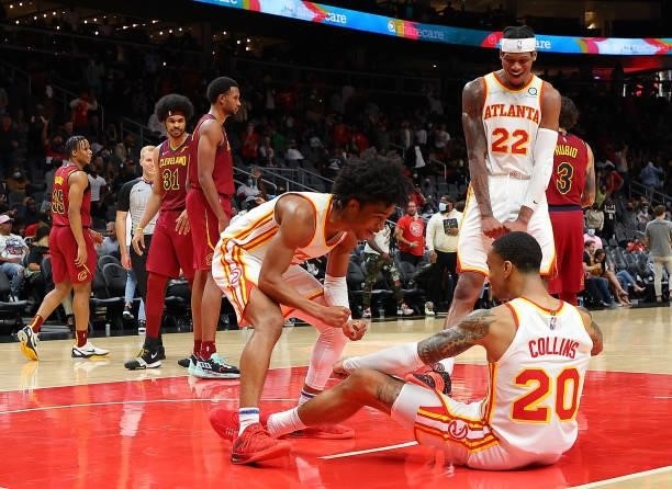 John Collins of the Atlanta Hawks reacts after a dunk over Jarrett Allen of the Cleveland Cavaliers with Sharife Cooper and Cam Reddish during the...