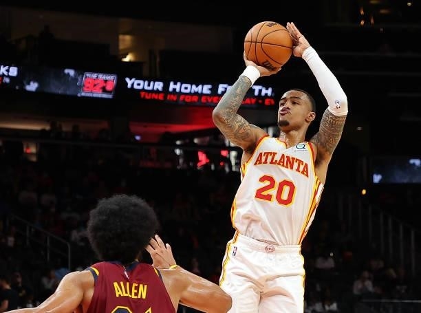 John Collins of the Atlanta Hawks attempts a shot over Jarrett Allen of the Cleveland Cavaliers during the second half at State Farm Arena on October...