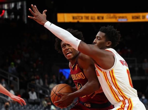 Collin Sexton of the Cleveland Cavaliers drives against Brandon Goodwin of the Atlanta Hawks during the first half at State Farm Arena on October 06,...