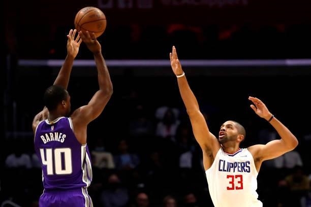 Harrison Barnes of the Sacramento Kings takes a shot against Nicolas Batum of the Los Angeles Clippers during the first quarter of the preseason game...