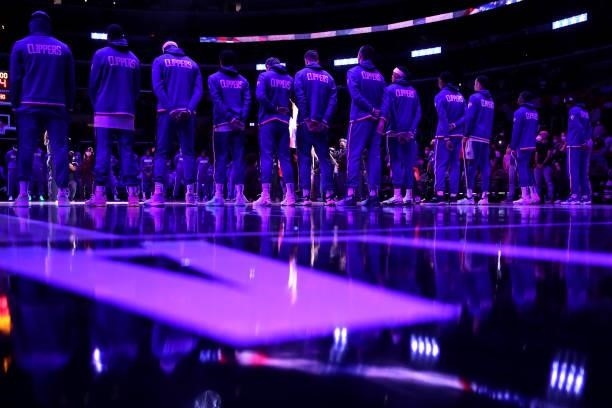 The Los Angeles Clippers stand for the national anthem before the preseason game against the Sacramento Kings at Staples Center on October 06, 2021...