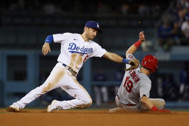 Tommy Edman of the St. Louis Cardinals steals second against Trea Turner of the Los Angeles Dodgers in the ninth inning during the National League...