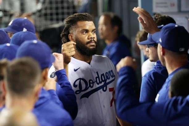 Teammates greet Kenley Jansen of the Los Angeles Dodgers in the dugout after the top of the ninth inning against the St. Louis Cardinals during the...