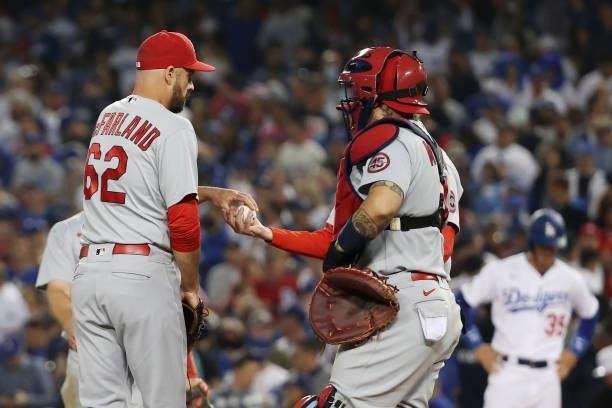 McFarland hands the ball to Yadier Molina of the St. Louis Cardinals as he leaves the game in the ninth inning against the Los Angeles Dodgers during...