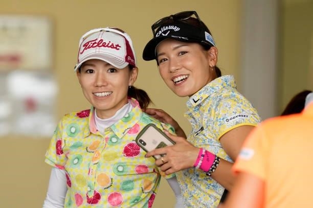 Nozomi Inoue and Hikari Fujita of Japan are seen at the club house as the play has been suspended due to heavy rain during the first round of...