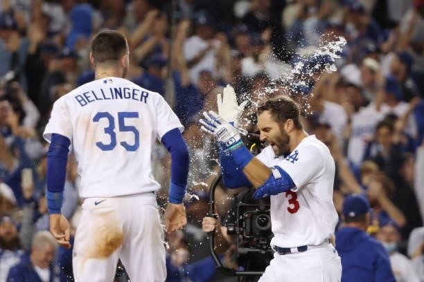 Chris Taylor of the Los Angeles Dodgers celebrates with Cody Bellinger after his walk off two-run home run in the ninth inning to defeat the St....