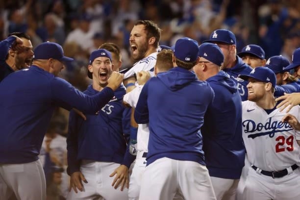 Chris Taylor of the Los Angeles Dodgers celebrates with teammates after his walk off two-run home run in the ninth inning to defeat the St. Louis...