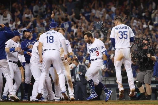 Chris Taylor of the Los Angeles Dodgers celebrates with teammates after his walk off two-run home run in the ninth inning to defeat the St. Louis...