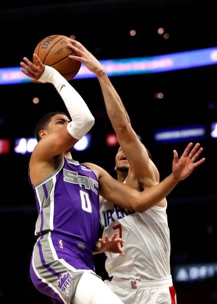 Amir Coffey of the Los Angeles Clippers blocks Tyrese Haliburton of the Sacramento Kings during the third quarter of the preseason game at Staples...