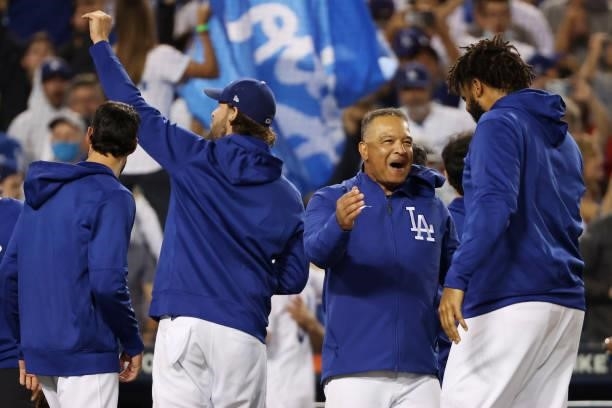Dave Roberts and Kenley Jansen of the Los Angeles Dodgers celebrate their 3 to 1 win over the St. Louis Cardinals in the National League Wild Card...