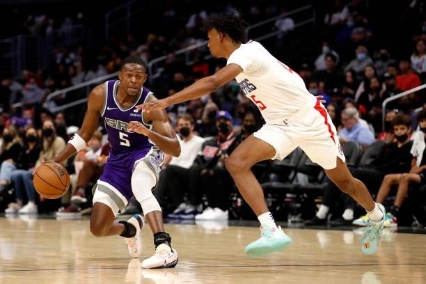 De'Aaron Fox of the Sacramento Kings controls the ball against Keon Johnson of the Los Angeles Clippers during the third quarter of the preseason...