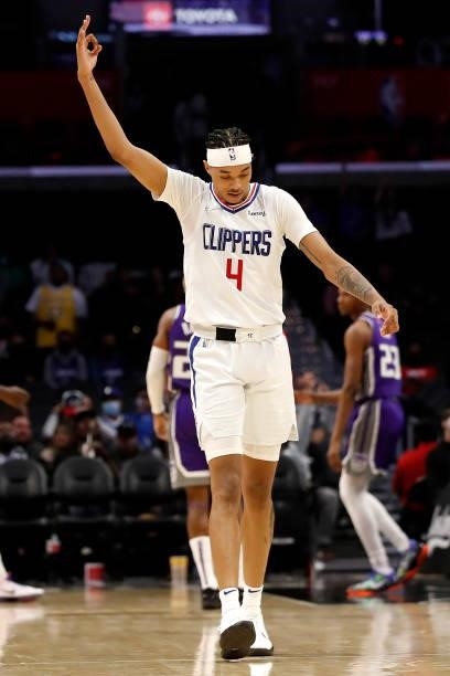 Brandon Boston Jr. #4 of the Los Angeles Clippers reacts after a three point basket by teammate Jay Scrubb during the fourth quarter of the preseason...