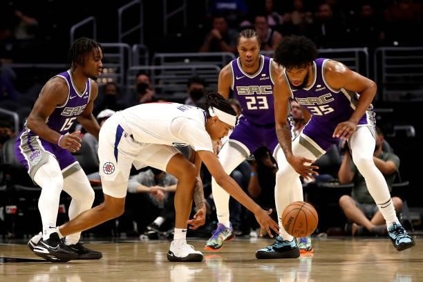 Brandon Boston Jr. #4 of the Los Angeles Clippers loses control of the ball against Davion Mitchell, Louis King and Marvin Bagley III of the...