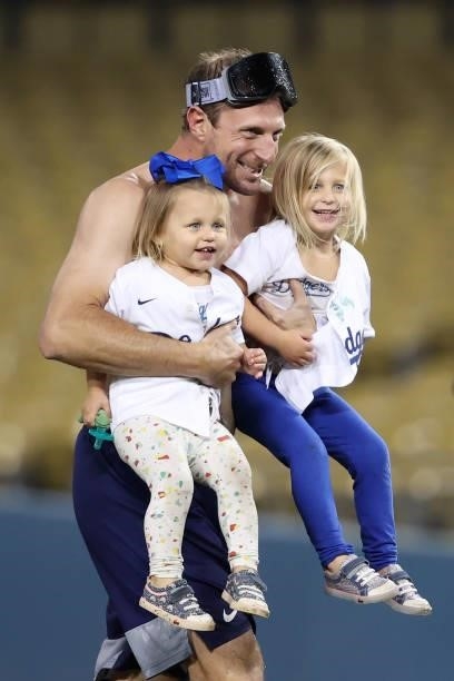 Max Scherzer of the Los Angeles Dodgers celebrates with his daughters Brooklyn and Kacey after they defeated the St. Louis Cardinals 3 to 1 during...