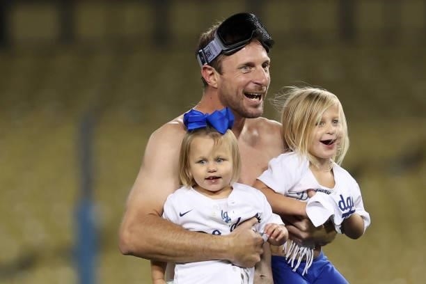 Max Scherzer of the Los Angeles Dodgers celebrates with his daughters Brooklyn and Kacey after they defeated the St. Louis Cardinals 3 to 1 during...