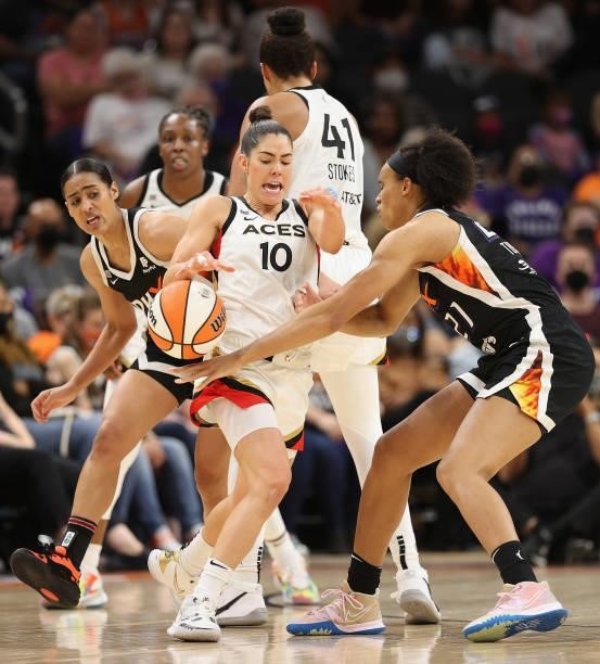 Kelsey Plum of the Las Vegas Aces attempts to control the ball under pressure from Brianna Turner of the Phoenix Mercury during the second half in...