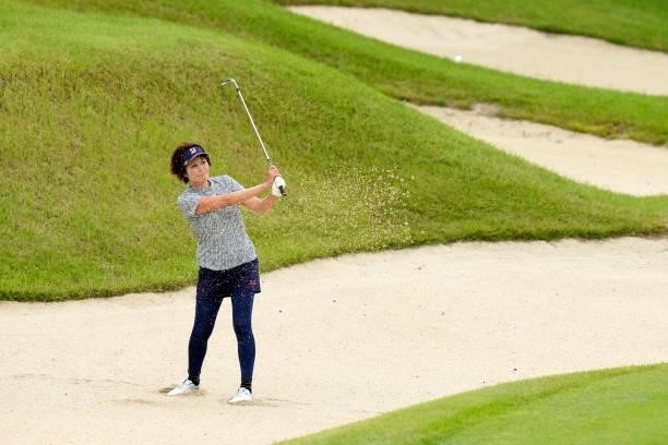 Tomoko Kanai of Japan hits out from a bunker on the 18th hole during the first round of Kanehide Miyarabi Open at the Kanehide Kise Country Club on...