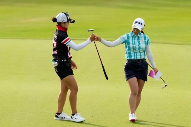 Sae Ogura and Minori Hashizoe of Japan fist bump after holing out on the 18th green during the first round of Kanehide Miyarabi Open at the Kanehide...
