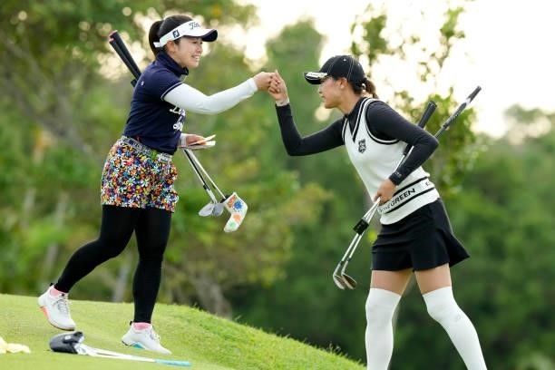Mika Nakazono and Shiho Kawasaki of Japan fist bump after holing out on the 9th green during the first round of Kanehide Miyarabi Open at the...