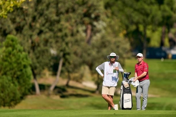 Jonathan Caldwell of Northern Ireland talks with his caddie during Day One of The Acciona Open de Espana at Club de Campo Villa de Madrid on October...