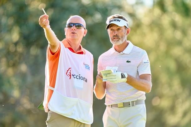 Raphael Jacquelin of France talks with his caddie during Day One of The Acciona Open de Espana at Club de Campo Villa de Madrid on October 07, 2021...