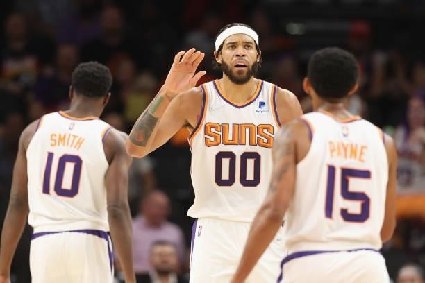 JaVale McGee of the Phoenix Suns high fives Cameron Payne during the NBA preseason game at Footprint Center on October 06, 2021 in Phoenix, Arizona....