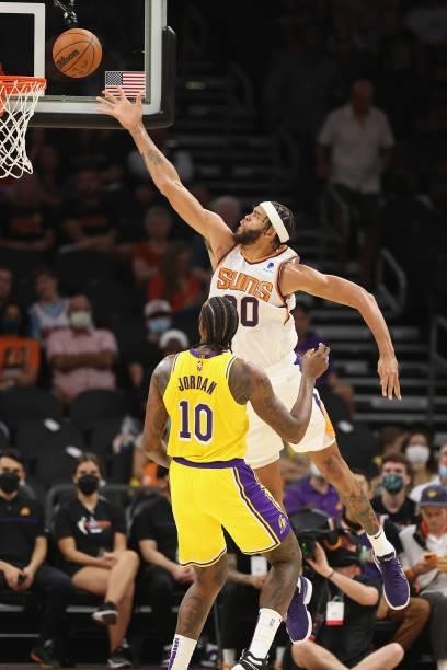 JaVale McGee of the Phoenix Suns lays up a shot over DeAndre Jordan of the Los Angeles Lakers during the NBA preseason game at Footprint Center on...