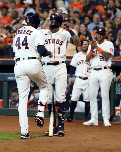 Yordan Alvarez of the Houston Astros is congratulated at home plate by Carlos Correa after hitting a solo home run during the 5th inning of Game 1 of...