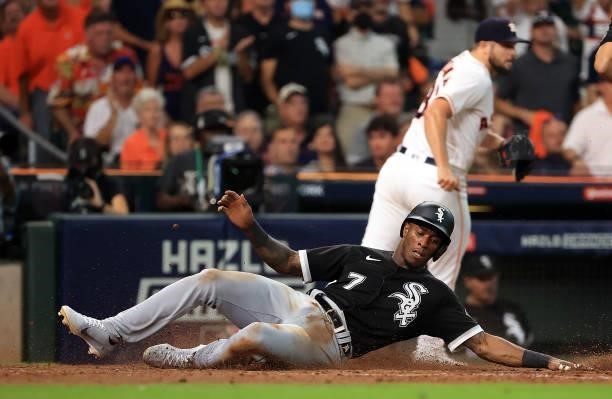 Tim Anderson of the Chicago White Sox slides safely into home to score during the 8th inning of Game 1 of the American League Division Series against...