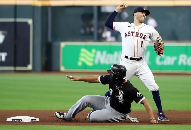 Carlos Correa of the Houston Astros throws toward first for a double play during the 7th inning of Game 1 of the American League Division Series...