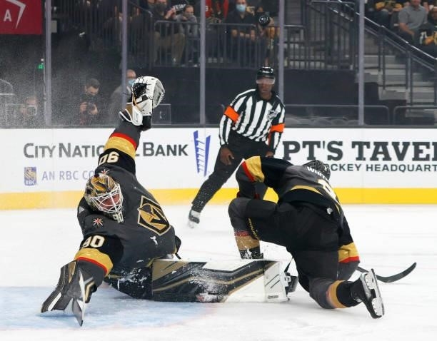 Robin Lehner of the Vegas Golden Knights reacts as a shot by Nick Schmaltz of the Arizona Coyotes ricochets off of a skate of Zach Whitecloud of the...
