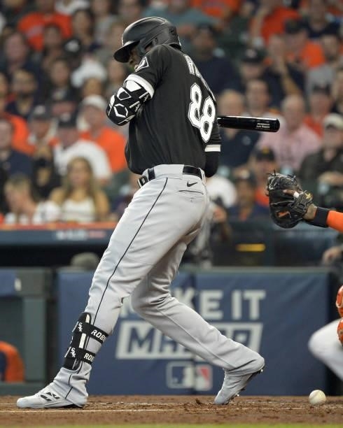 Luis Robert of the Chicago White Sox reacts after being hit by a pitch in the second inning against the Houston Astros during Game One of the...