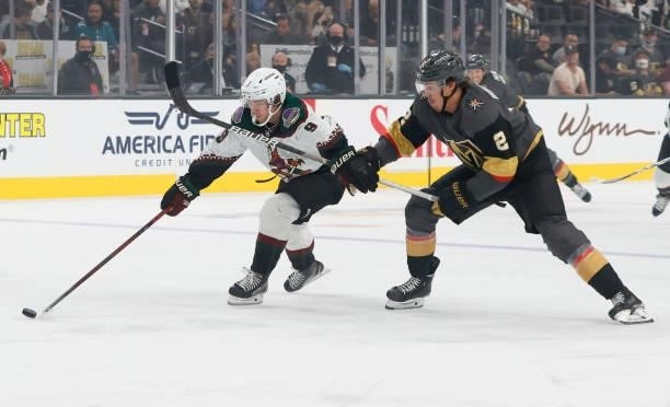 Clayton Keller of the Arizona Coyotes skates with the puck against Zach Whitecloud of the Vegas Golden Knights in the first period of their preseason...