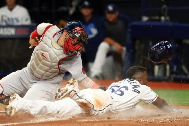 Randy Arozarena of the Tampa Bay Rays steals home against Christian Vazquez of the Boston Red Sox in the seventh inning during Game 1 of the American...
