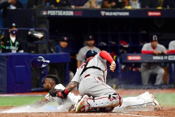 Randy Arozarena of the Tampa Bay Rays steals home against Christian Vazquez of the Boston Red Sox in the seventh inning during Game 1 of the American...