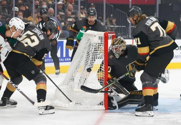 Dylan Coghlan, Robin Lehner and William Karlsson defend the net against Ryan Dzingel of the Arizona Coyotes of the Vegas Golden Knights in the first...