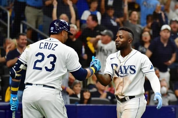 Randy Arozarena of the Tampa Bay Rays celebrates with Nelson Cruz after stealing home in the seventh inning against the Boston Red Sox during Game 1...