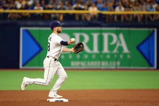 Brandon Lowe of the Tampa Bay Rays turns a double play to end the sixth inning against the Boston Red Sox during Game 1 of the American League...