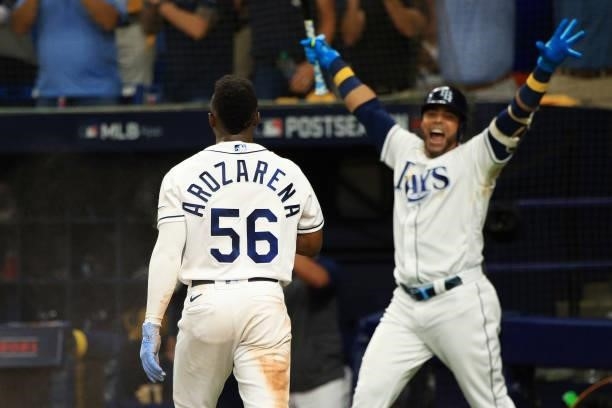 Randy Arozarena of the Tampa Bay Rays celebrates after stealing home with Nelson Cruz in the seventh inning against the Boston Red Sox during Game 1...
