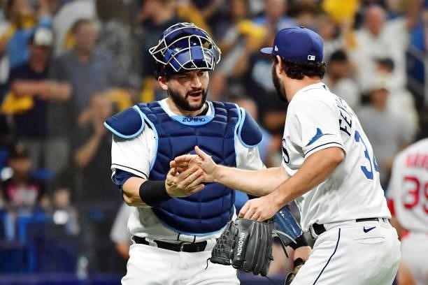Mike Zunino and J.P. Feyereisen of the Tampa Bay Rays celebrate after the top of the eighth inning against the Boston Red Sox during Game 1 of the...