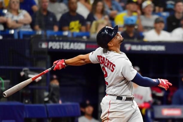 Xander Bogaerts of the Boston Red Sox hits a single in the eighth inning against the Tampa Bay Rays during Game 1 of the American League Division...