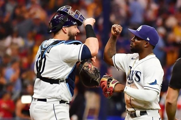 Randy Arozarena and Mike Zunino of the Tampa Bay Rays celebrate their 5-0 win over the Boston Red Sox during Game 1 of the American League Division...