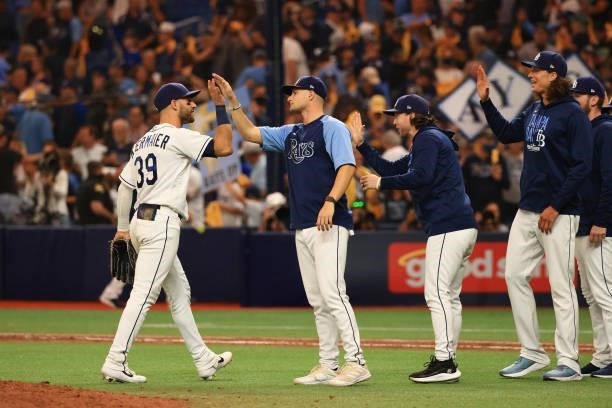 Kevin Kiermaier of the Tampa Bay Rays celebrates with teammates after their 5-0 win over the Boston Red Sox during Game 1 of the American League...
