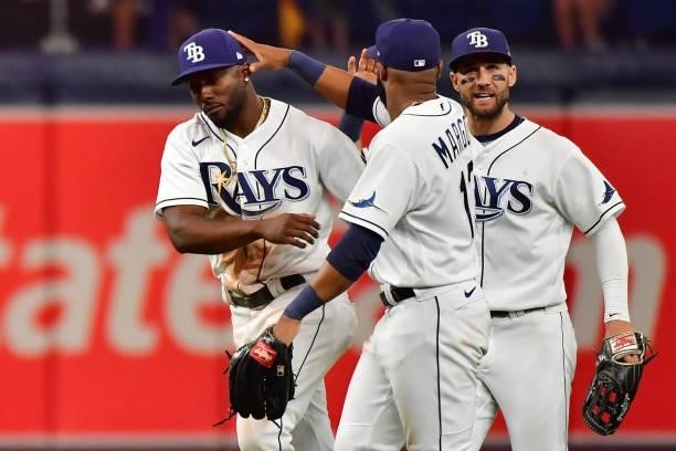 Randy Arozarena of the Tampa Bay Rays, Manuel Margot and Kevin Kiermaier celebrate their 5-0 win over the Boston Red Sox during Game 1 of the...