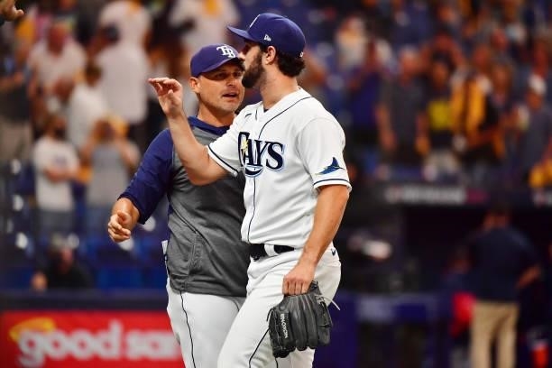 Kevin Cash celebrates with J.P. Feyereisen of the Tampa Bay Rays after their 5-0 win over the Boston Red Sox during Game 1 of the American League...