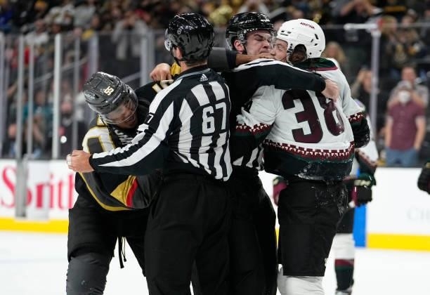 Keegan Kolesar of the Vegas Golden Knights and Liam O'Brien of the Arizona Coyotes are separated after fighting during the second period of a game at...