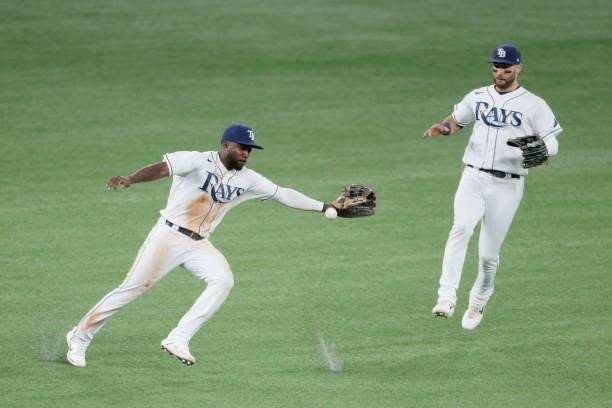 Randy Arozarena and Kevin Kiermaier of the Tampa Bay Rays fail to make the play on a single by Xander Bogaerts of the Boston Red Sox in the eighth...